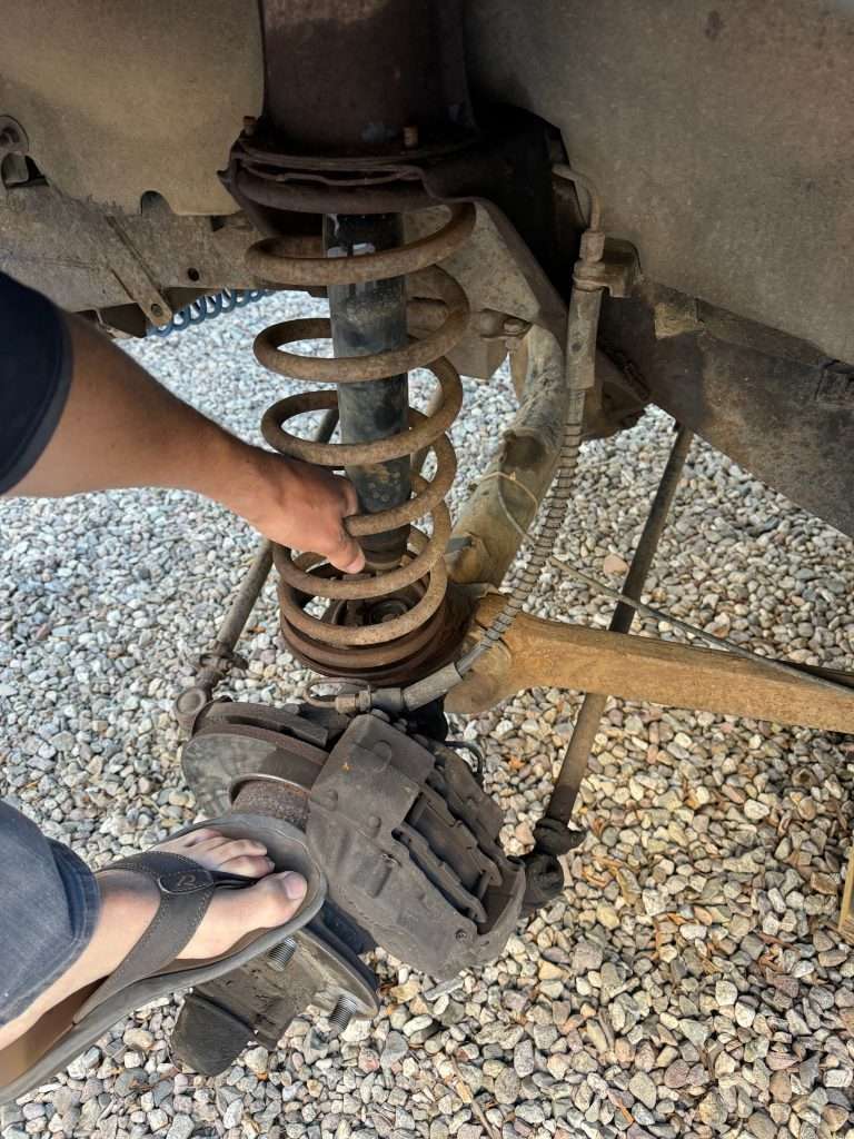 Make sure you're wearing flip-flops when you press down on the axle to release the coil spring.