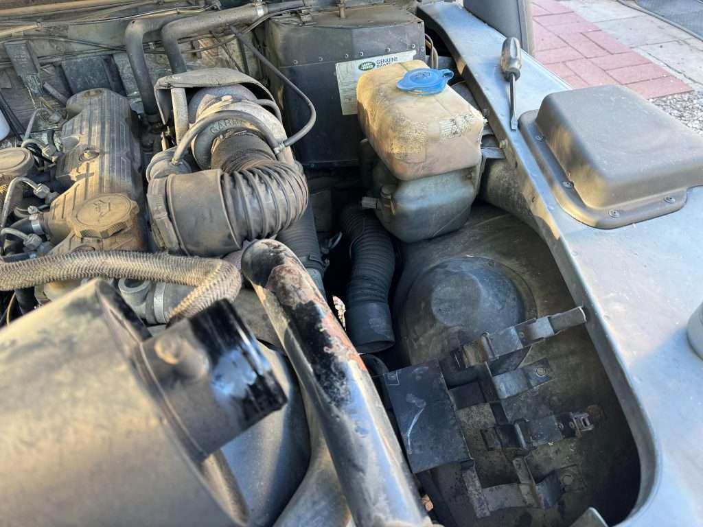 Removing the access cover located on both front fenders inside the engine compartment makes the whole process a lot easier.