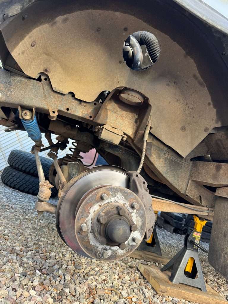 Completely disassembled with the old parts in the garbage bin. This side is ready for new springs and shocks.