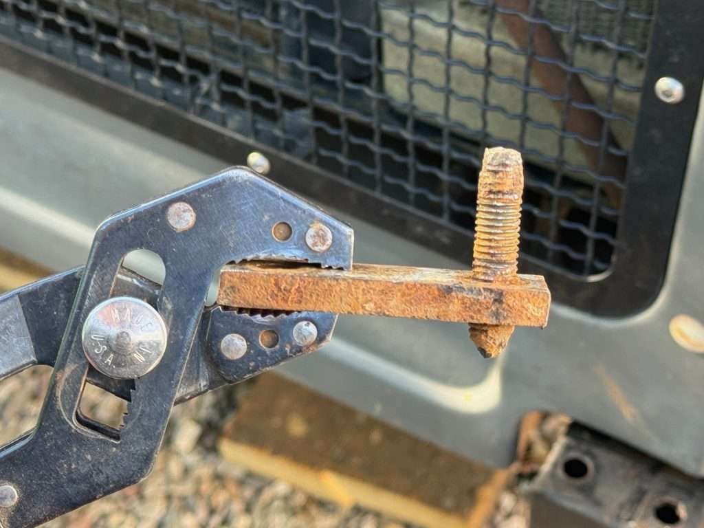 With some twisting and contorting, and good tug, I was able to remove the nut-plate with the broken bolt fragment from the frame rail.