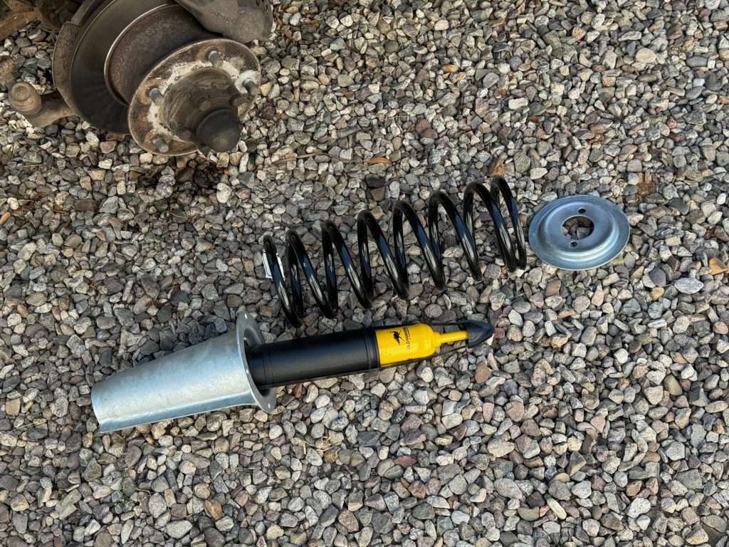 An Old Man Emu shock absorber, a ProLine coil spring, and a galvanized spring tower set from Rovers North