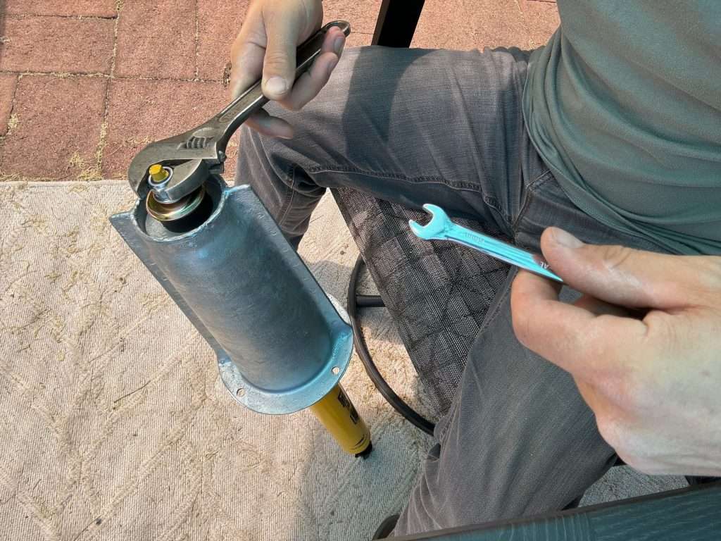 Installing the top of the shock onto the new shock tower in the comfort of one's patio