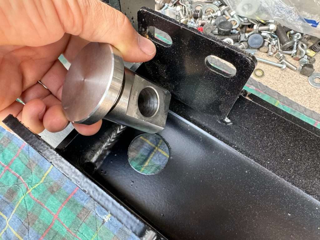 Insert the swivel shackle eyelet into the 1-3/8" hole on compatible steel bumper