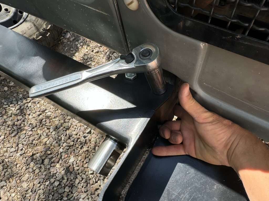 Inserting the two top bolts on the Land Rover Defender winch bumper