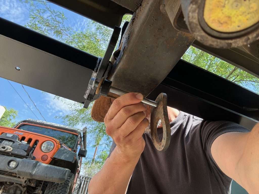 The lower horizontal bolt for the Defender winch bumper utilizes the bolt hole used to secure the tie down loop