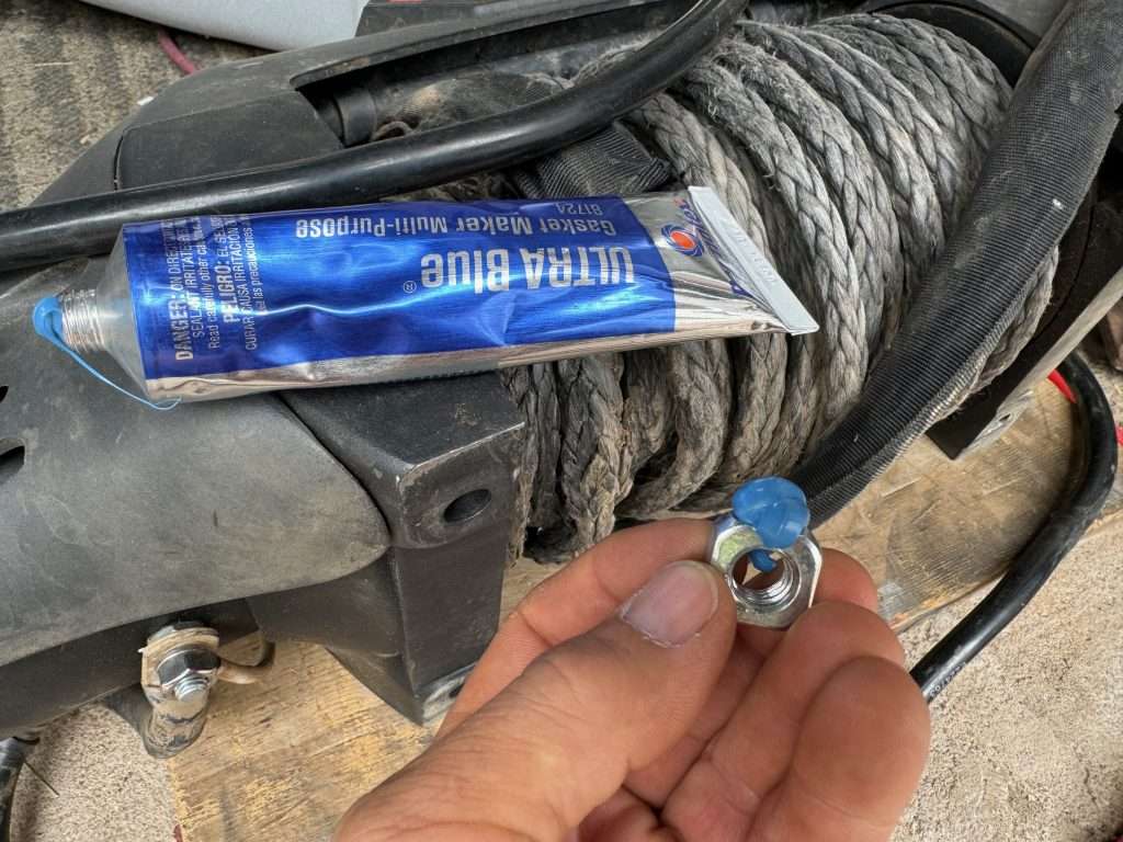 Some permatex gasket maker can be used to hold the winch seat nuts in place