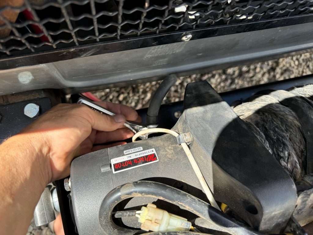 The negative power cable connected to the underside of the winch motor. It was easy to get to once the winch was unbolted from the mounting plate.