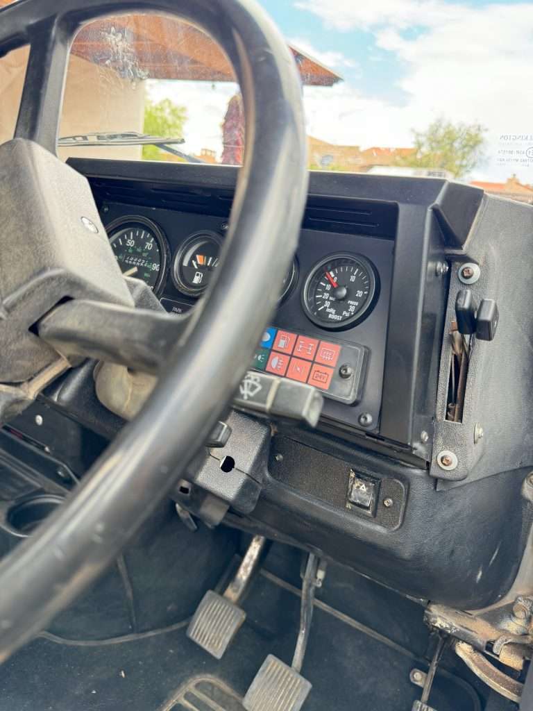 The sleek black powder-coated binnacle doesn't quite match the 30 year old faded dashboard plastic. Oh well.
