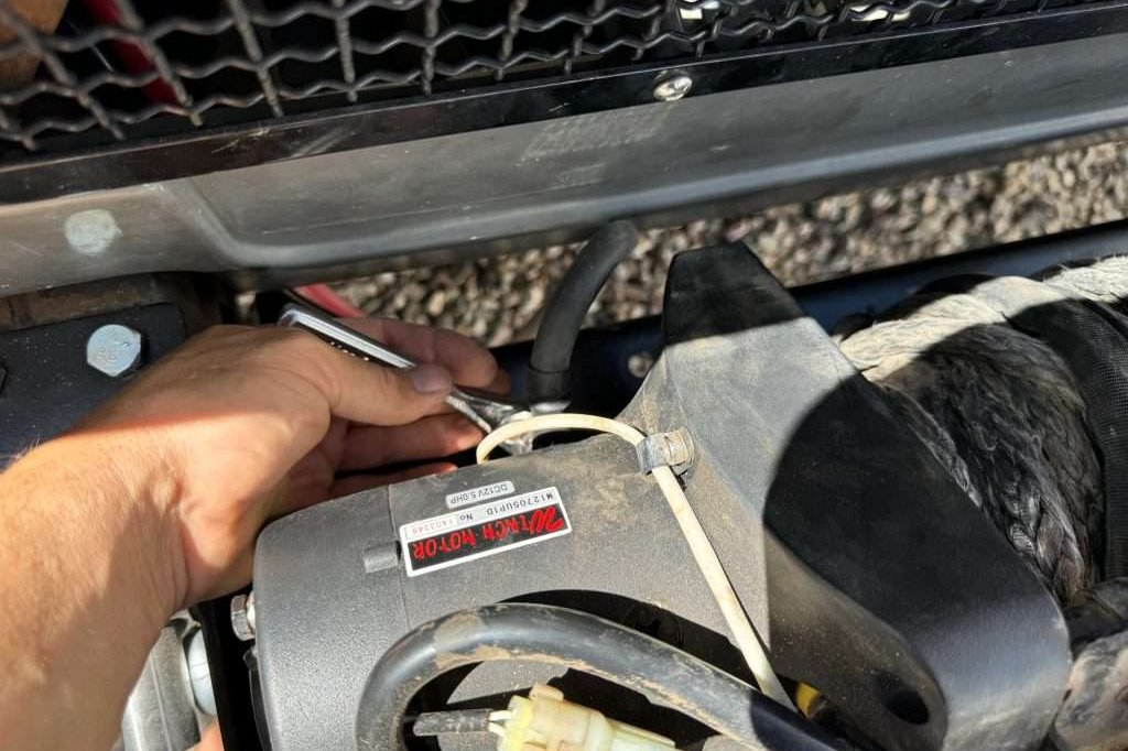 The negative power cable connected to the underside of the winch motor. It was easy to get to once the winch was unbolted from the mounting plate.