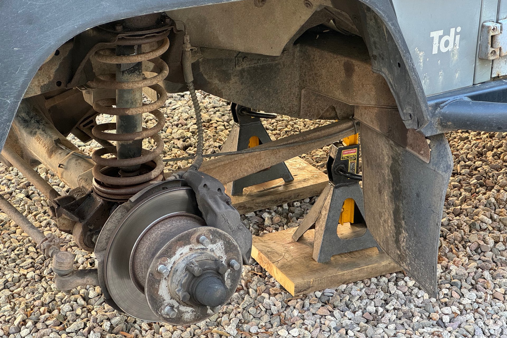 Dismantling the front suspension of the Defender to make way for the new springs and shocks