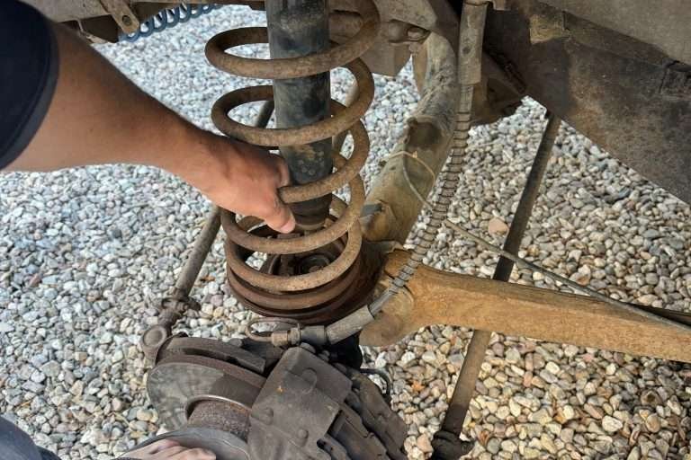 Make sure you're wearing flip-flops when you press down on the axle to release the coil spring.