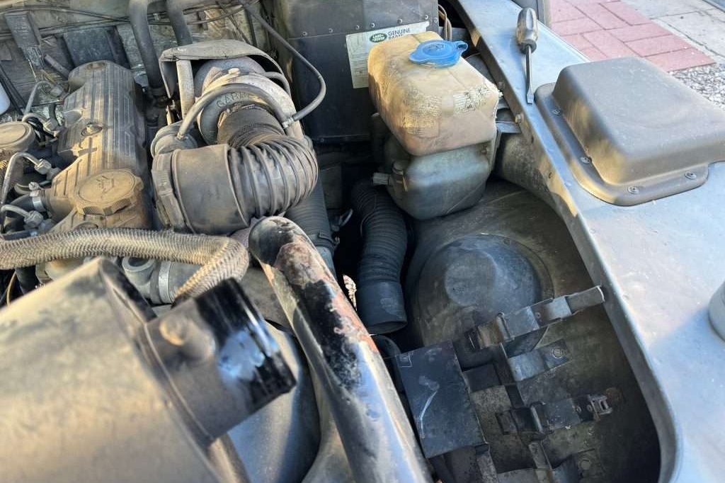 Removing the access cover located on both front fenders inside the engine compartment makes the whole process a lot easier.