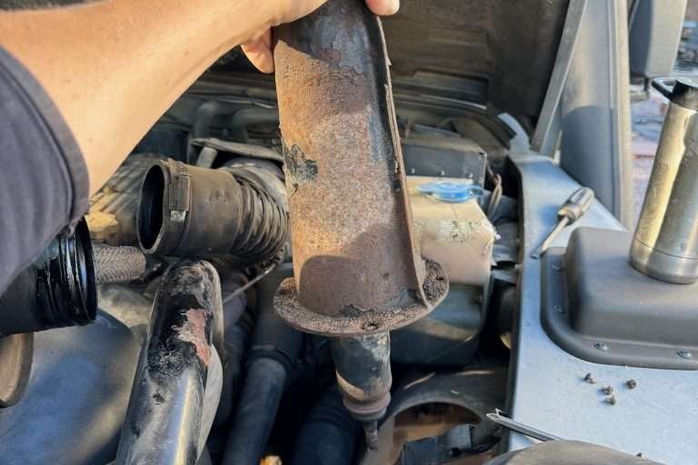 Yoink! Removing the old shock tower with shock still attached at the top.