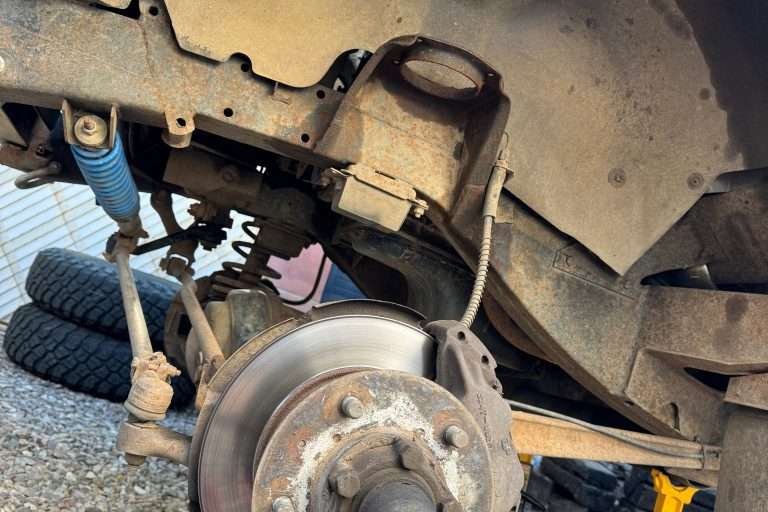 Completely disassembled with the old parts in the garbage bin. This side is ready for new springs and shocks.