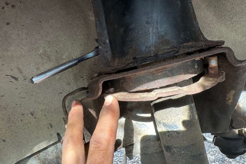 The driver's side stud plate was much rustier than the passenger's side, and did not remain intact as I disassembled the shock tower.