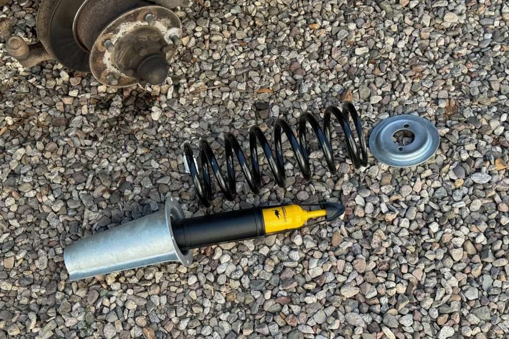 An Old Man Emu shock absorber, a ProLine coil spring, and a galvanized spring tower set from Rovers North