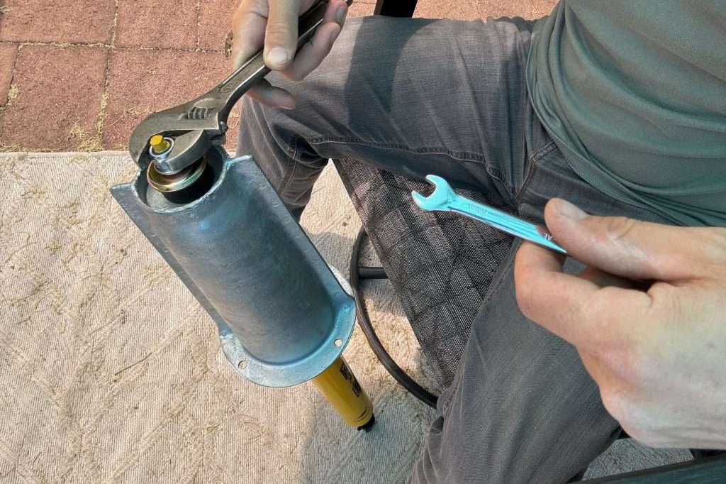 Installing the top of the shock onto the new shock tower in the comfort of one's patio