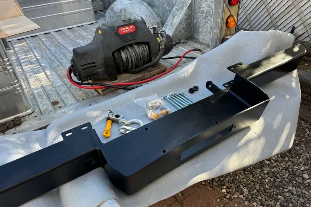 COMEUP Winch and Defender winch bumper all laid out on the bed of the Hi-Cap, ready to install