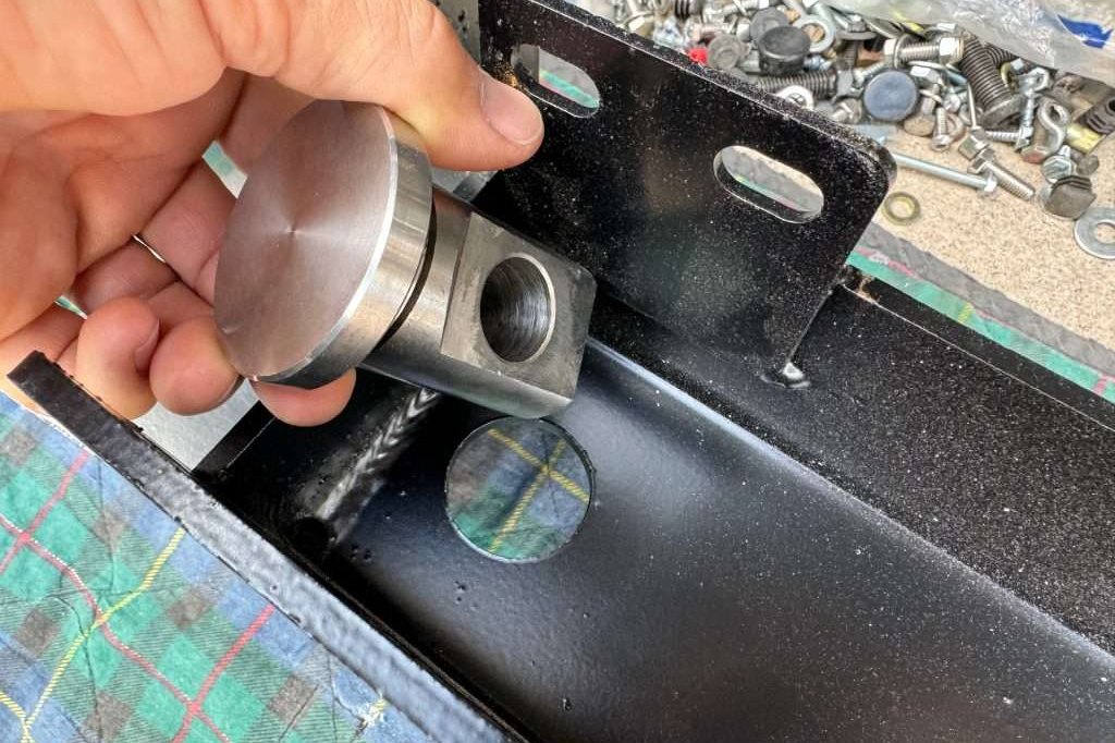 Insert the swivel shackle eyelet into the 1-3/8" hole on compatible steel bumper