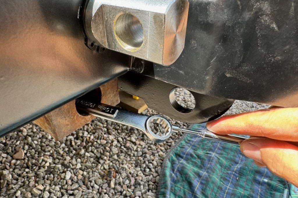 A 15mm wrench inserted completely into the frame rail will make it easy to hold the lower nuts as you tighten the bumper bolts, and can be retrieved with a telescoping magnet