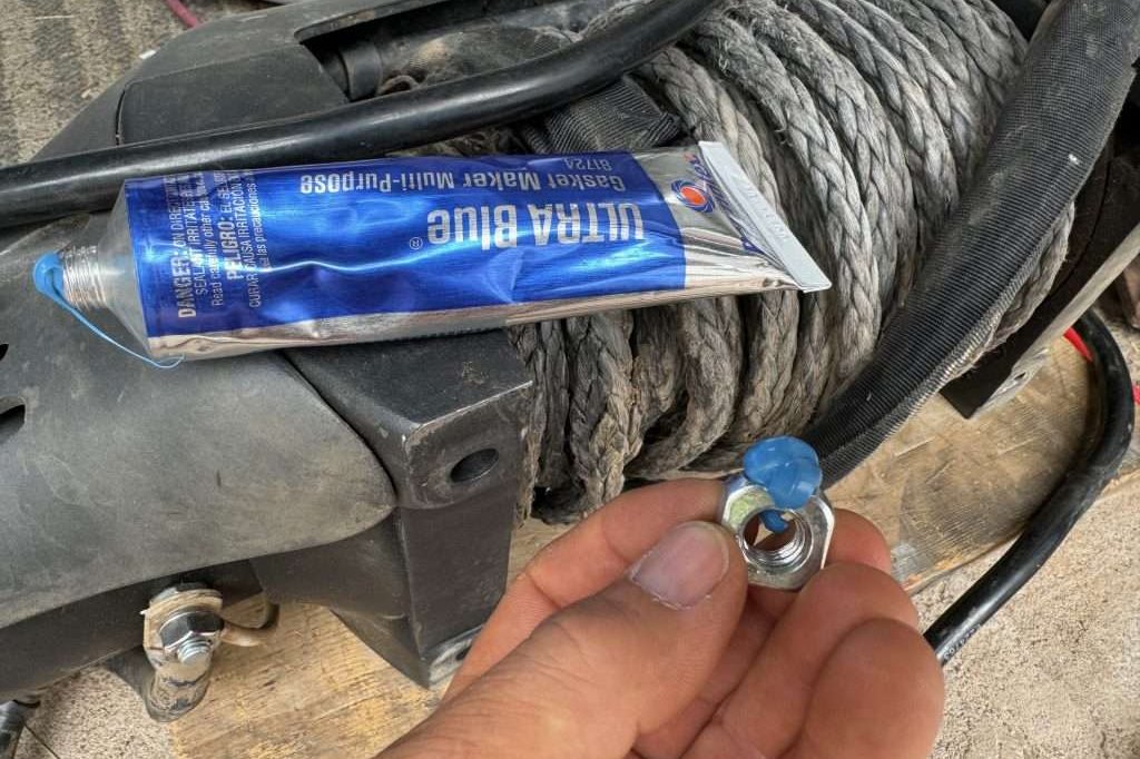 Some permatex gasket maker can be used to hold the winch seat nuts in place