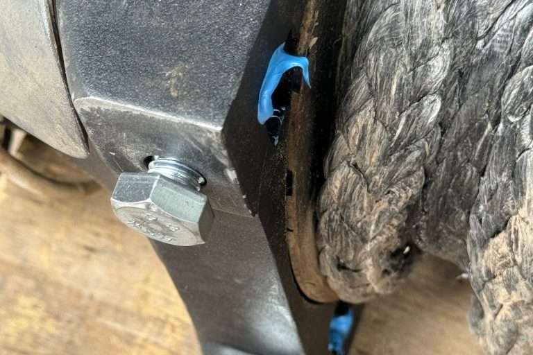 Thread the bolts into the winch seat for a few minutes until the permatex sets with the nuts in position