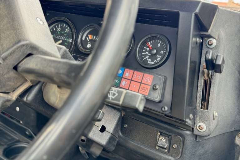 The sleek black powder-coated binnacle doesn't quite match the 30 year old faded dashboard plastic. Oh well.