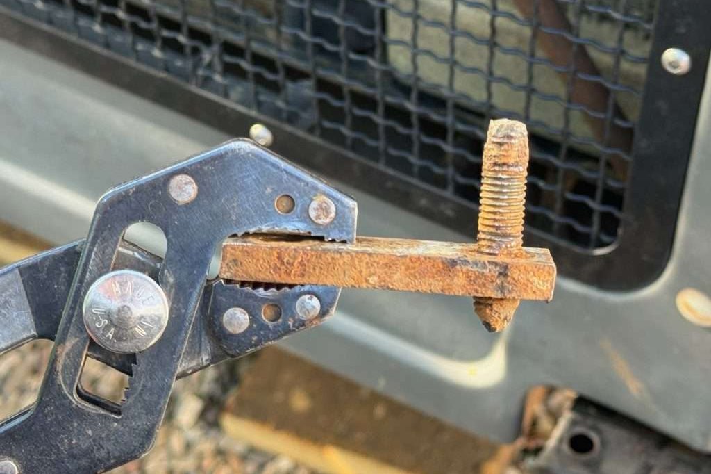 With some twisting and contorting, and good tug, I was able to remove the nut-plate with the broken bolt fragment from the frame rail.